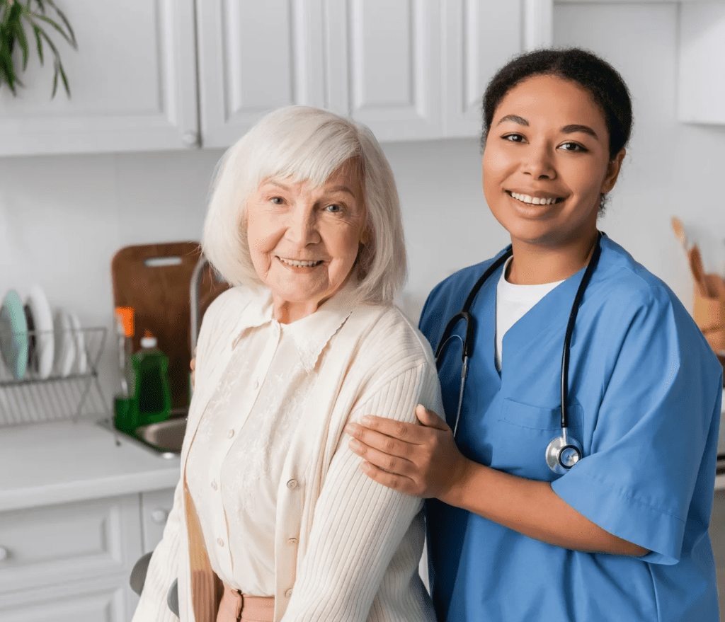 A nurse and an older woman standing next to each other.