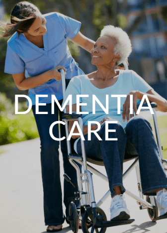 A woman in a wheelchair with a nurse nearby.