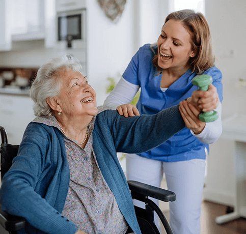 A woman is helping an older person in a wheelchair.