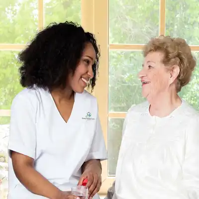 A woman and an older person smiling for the camera.