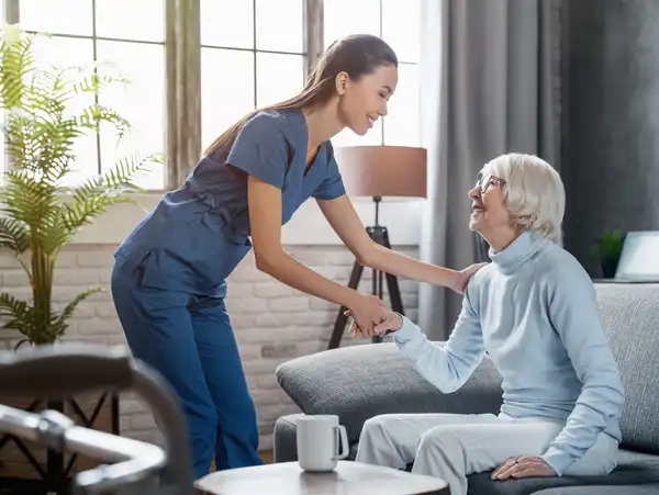 A woman is helping an elderly man