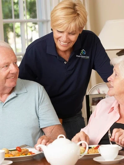 A woman and two elderly people are playing video games.