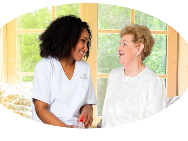 A woman and an older person smiling for the camera.