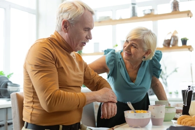 A man and woman sitting at a table with bowls of food.