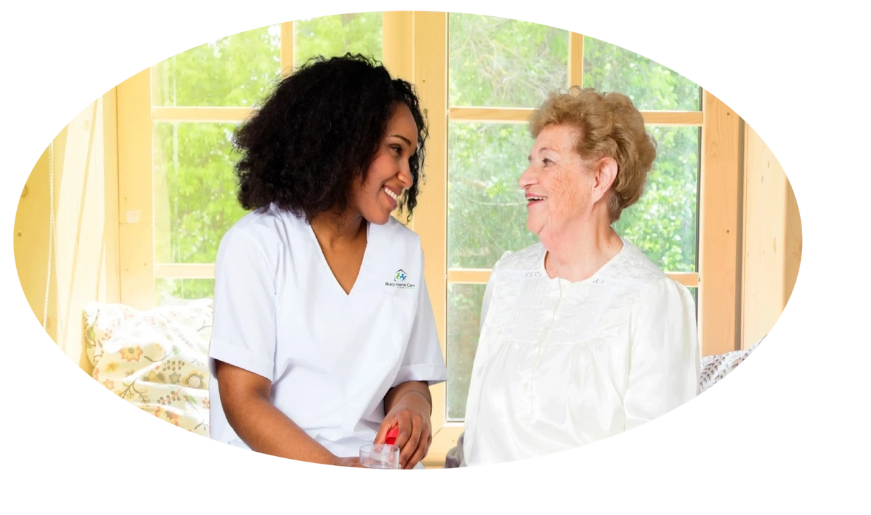 A woman and an older person smiling for the camera.