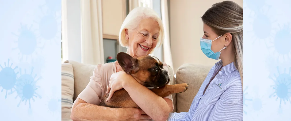 A woman holding a dog in her arms.