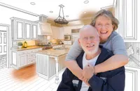 A man and woman are hugging in the kitchen.