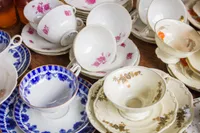 A table full of white dishes and bowls.