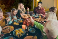 A family sitting at the dinner table eating.