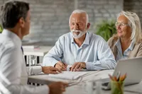 A group of people sitting around a table.