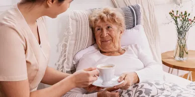 A person holding a cup of coffee in their hand.