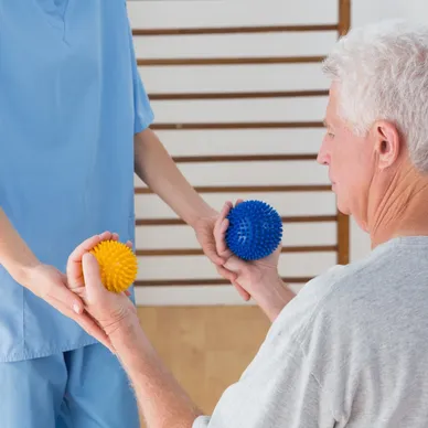 A man holding two balls in his hands