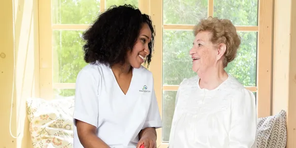 A woman and an older person smiling for the camera.