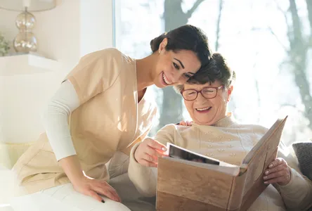 A woman and an elderly person looking in a box.