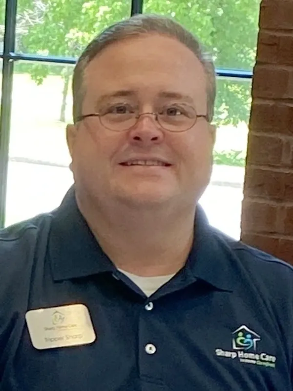 A man with glasses and a blue shirt