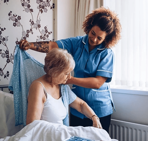 A woman in blue shirt and nurse putting on clothes.