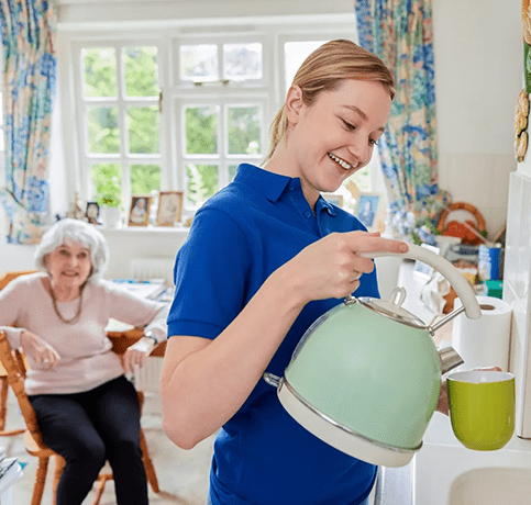 A woman holding a tea pot in her hand.