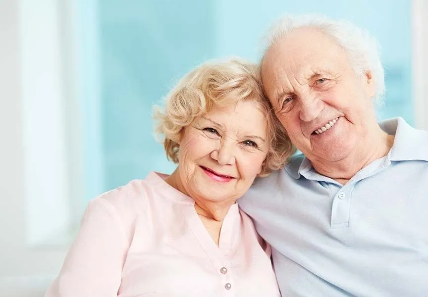 A man and woman are smiling for the camera.