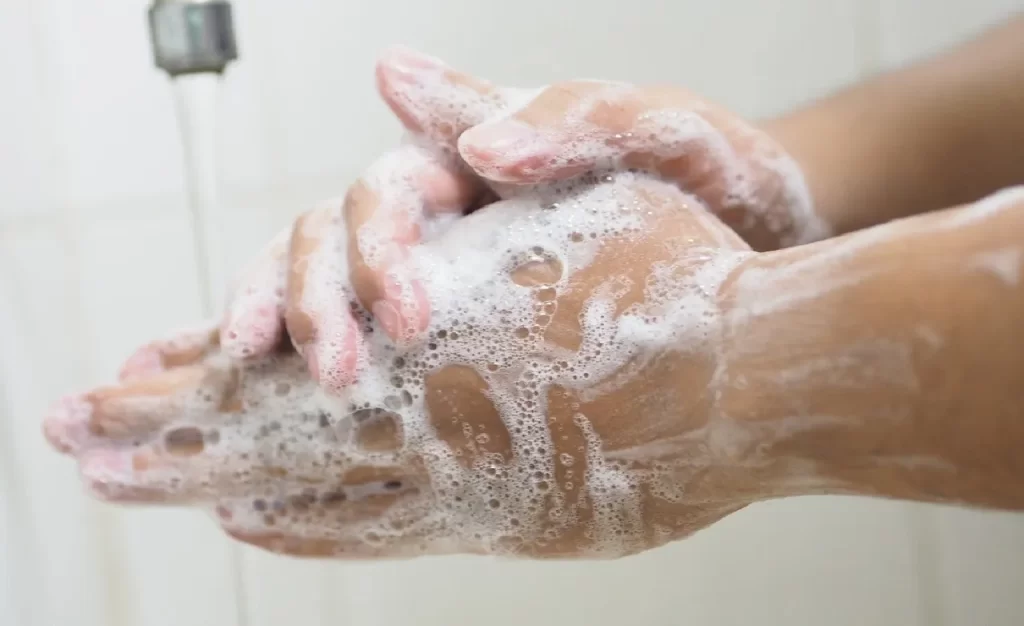 A person washing their hands in the shower