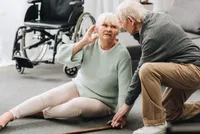 A man and woman sitting on the ground.