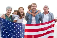 A group of people holding an american flag.